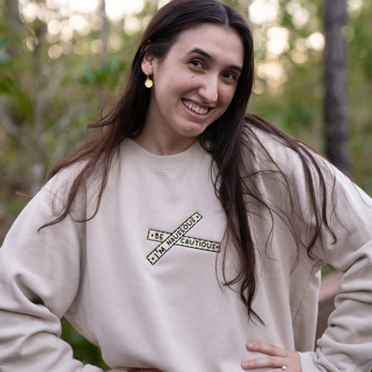 "Be Cautious, I'm Nauseous" embroidered crewneck