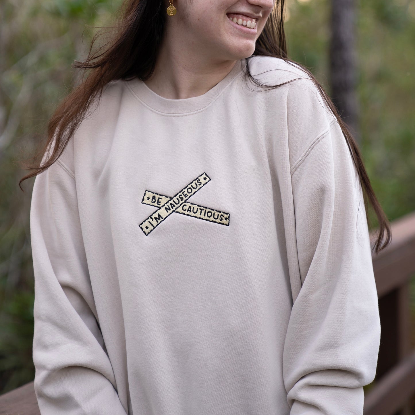 "Be Cautious, I'm Nauseous" embroidered crewneck